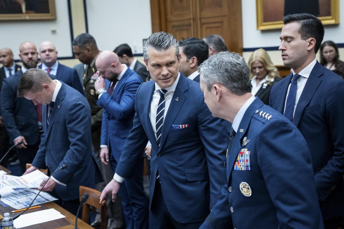 Defense Secretary Pete Hegseth chats with Gen. Dan Caine, chairman of the Joint Chiefs of Staff, during a pause in a House Armed Services Committee hearing on the Department of Defense's budget request on Capitol Hill in Washington, on Wednesday, April 29, 2026. (Haiyun Jiang/The New York Times)