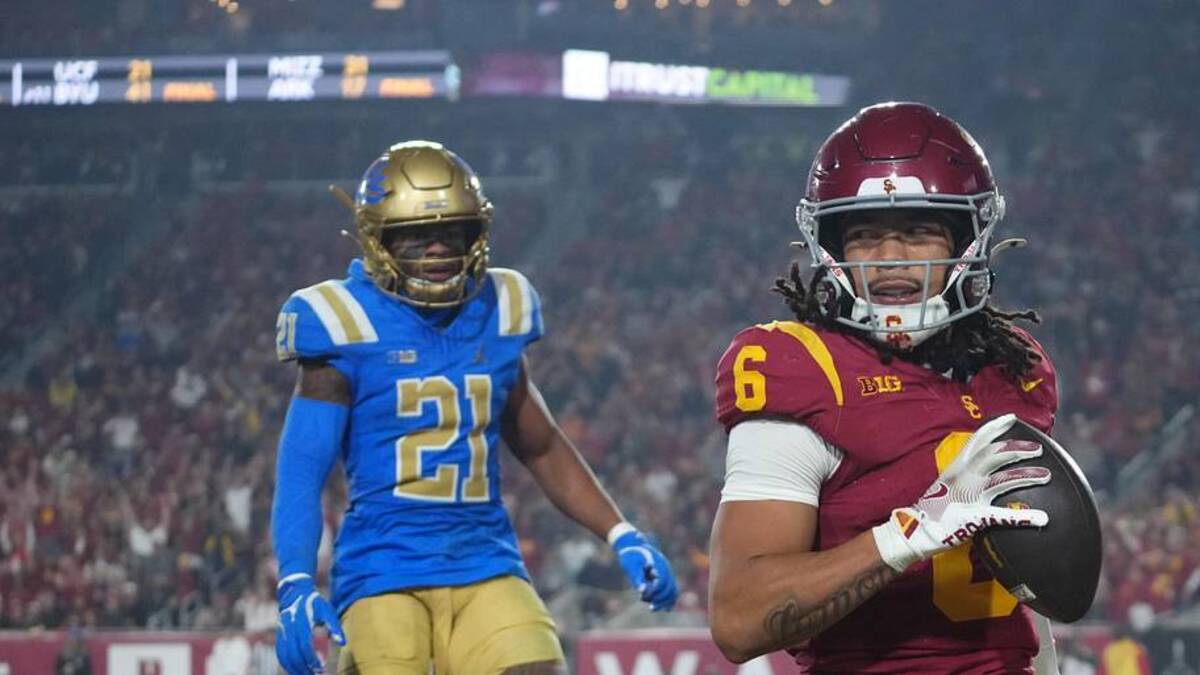  Nov 29, 2025; Los Angeles, California, USA; Southern California Trojans wide receiver Makai Lemon (6) catches a 32-yard touchdown pass against UCLA Bruins defensive back Kanye Clark (1) in the second half at United Airlines Field at Los Angeles Memorial Coliseum. Mandatory Credit: Kirby Lee-Imagn Images | Kirby Lee-Imagn Images 