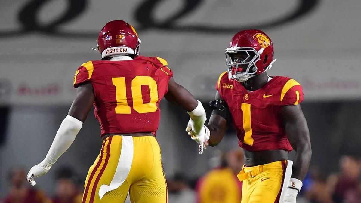  Sep 20, 2025; Los Angeles, California, USA; Southern California Trojans defensive end Braylan Shelby (10) celebrates with defensive end Kameryn Crawford (1) after bringing down Michigan State Spartans quarterback Aidan Chiles (2) during the first half at the Los Angeles Memorial Coliseum. Mandatory Credit: Gary A. Vasquez-Imagn Images | Gary A. Vasquez-Imagn Images 