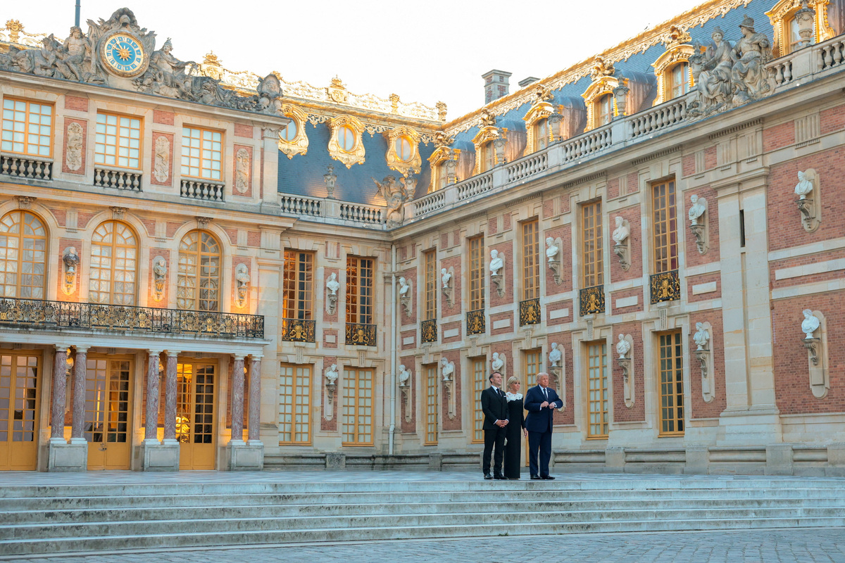 FILE PHOTO: President of France Emmanuel Macron, his wife Brigitte Macron and U.S. President Donald Trump pose for a photo outside Chateau de Versailles, France, June 17, 2026. Anna Moneymaker/Pool via REUTERS/File Photo