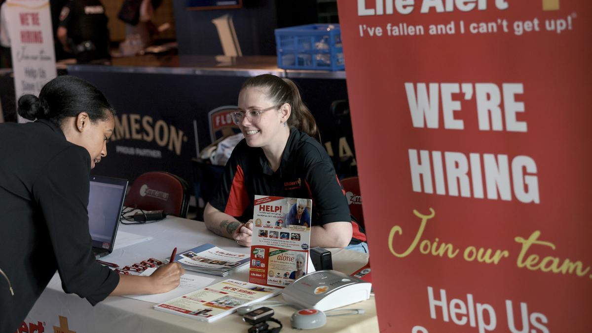 Stephanie Horrigan recruits for job opportunities at Life Alert during the Mega JobNewsUSA South Florida Job Fair held in the Amerant Bank Arena on April 30, 2026, in Sunrise, Florida. Hiring managers and recruiters for over 100 companies attended the job fair to recruit workers for positions in healthcare, public safety, trades, sales, logistics, government & more.