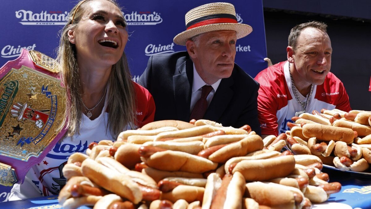 Reigning champions Miki Sudo and Jay Chestnut pose for a photo with Long-time Chairman and Commissioner of Major League Eating George Shea at the 110th Nathan's Famous Fourth of July International Hot Dog Eating Contest weigh-in ceremony at Hudson Yards on Friday in New York City. Photo by John Angelillo/UPI