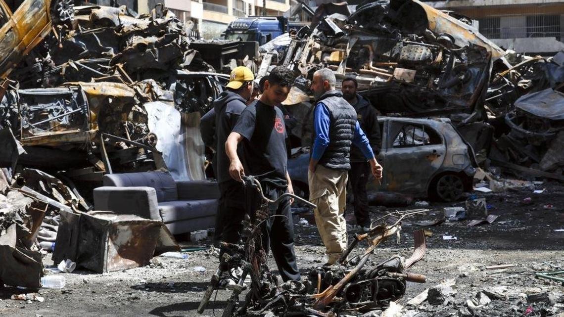 People walk Monday among the wreckage of cars in Corniche el Mazraa, one of the areas hit during a massive wave of Israeli airstrikes last week in Beirut, Lebanon, Photo by Wael Hamzeh/EPA
                                            
