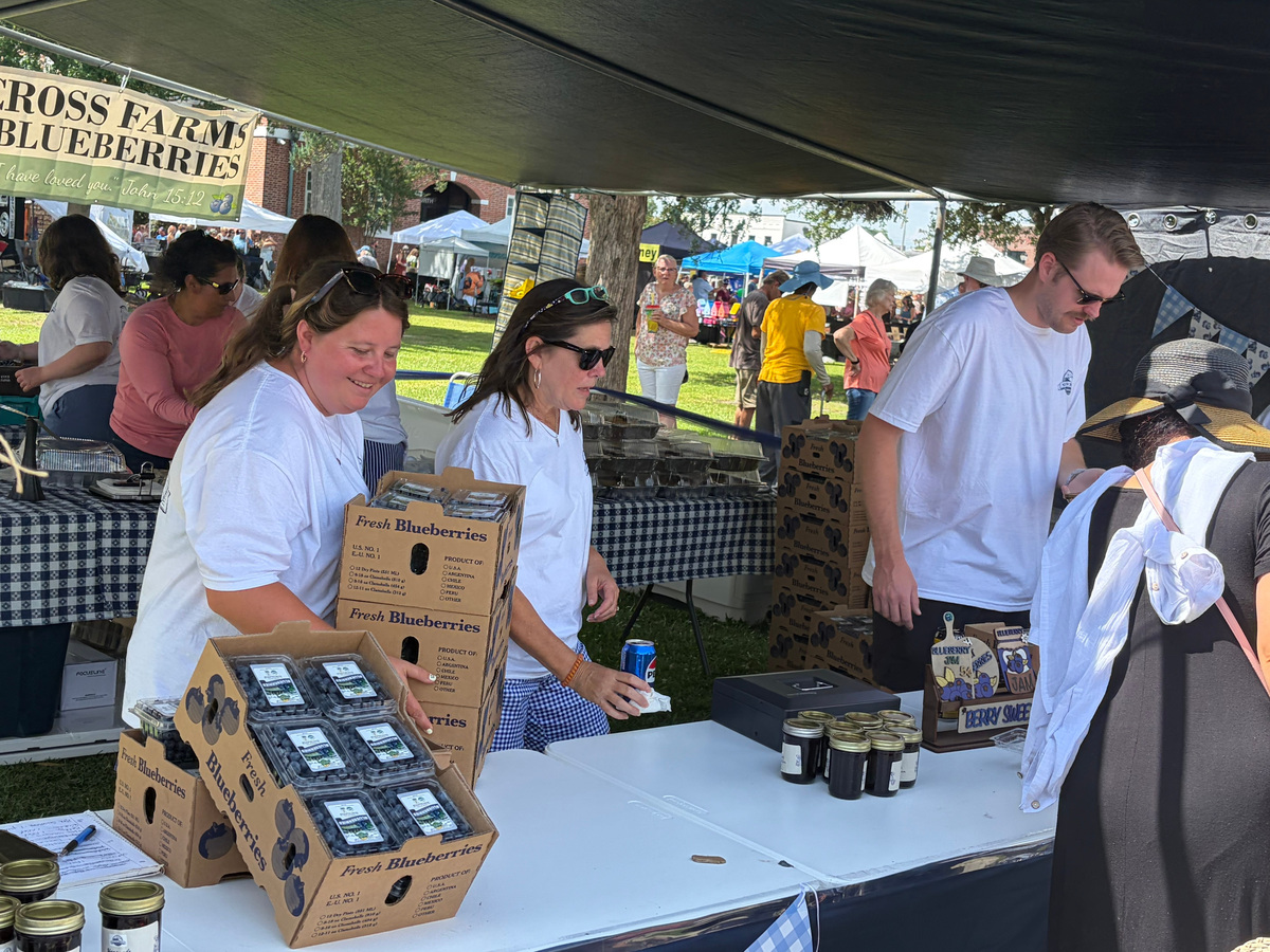 People lined up to purchase fresh blueberries from the local farms contributing the 2026 NC Blueberry Festival on June 20, including Altar Cross Farms seen here.