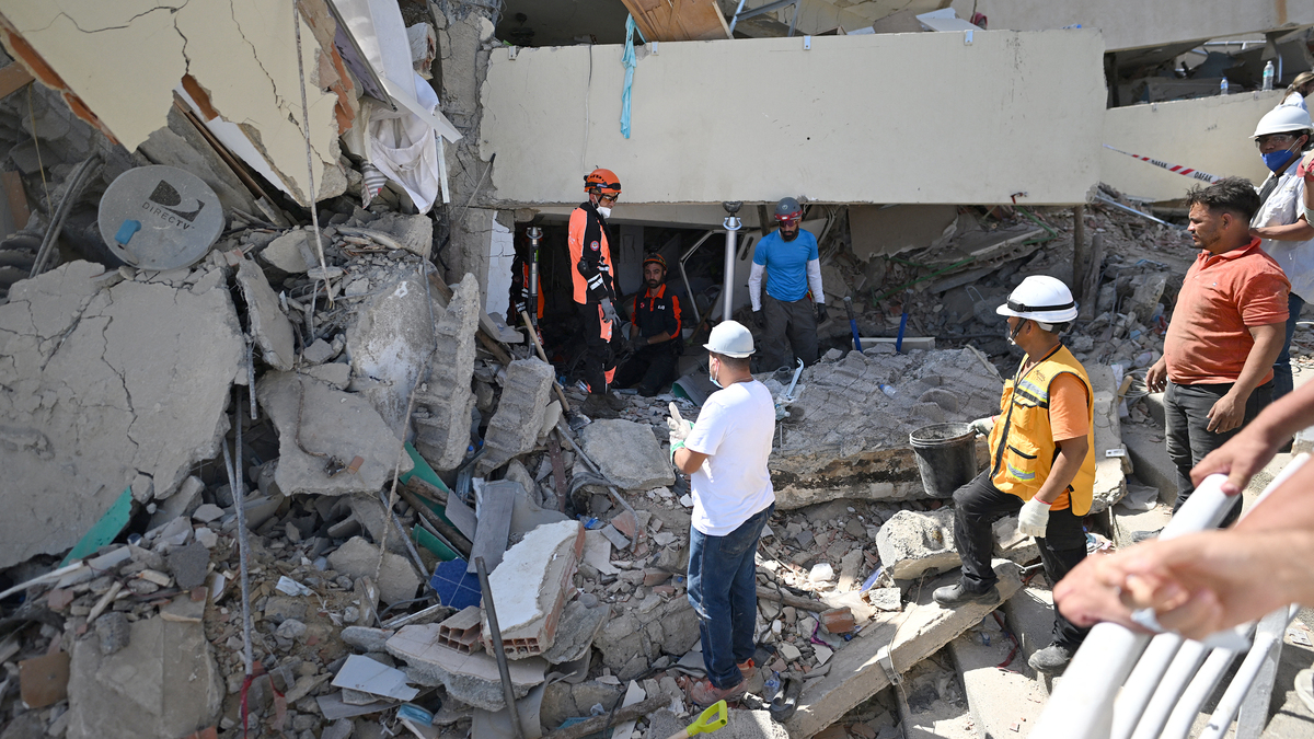 Turkish rescuers and volunteers search through the rubble of a collapsed building in Caraballeda, La Guaira state, Venezuela, on June 29, 2026, following twin earthquakes. Devastating back-to-back 7.2 and 7.5 magnitude earthquakes struck near Venezuela's Caribbean coast last week, collapsing buildings, damaging the country's main airport and leaving more than 1,700 people dead and tens of thousands missing. (Juan Barreto/AFP/Getty Images/TNS)