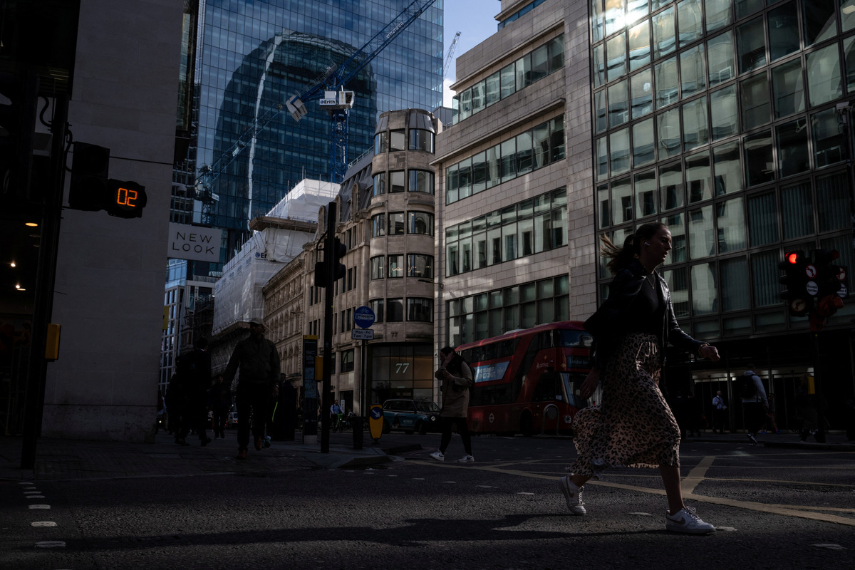 City workers walk through the City of London during the morning rush hour in London, Britain, June 9, 2026. REUTERS/Chris J. Ratcliffe