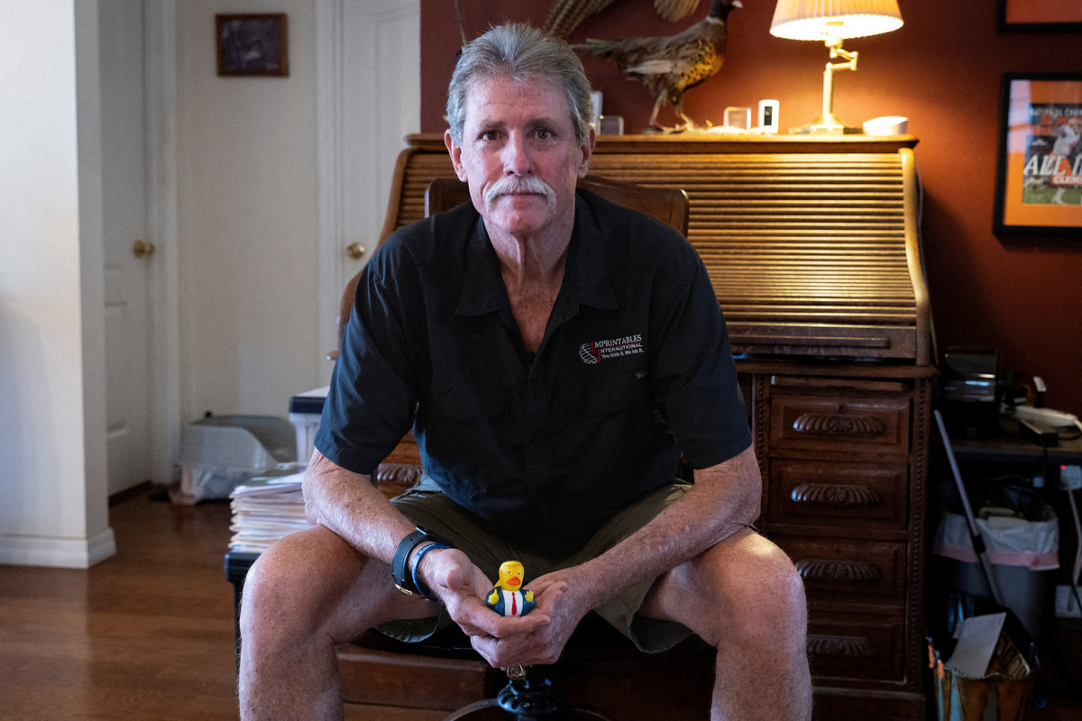 FILE PHOTO: Steve Egan, owner of a custom promotional items business, holds a U.S. President Donald Trump-themed rubber duck as he poses for a portrait during an interview with Reuters in Brandon, Florida, U.S. April 22, 2025. REUTERS/Marco Bello/File Photo