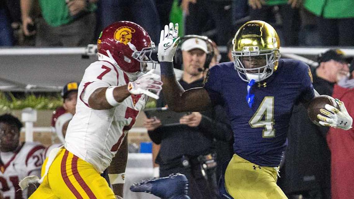  Oct 18, 2025; South Bend, Indiana, USA; Notre Dame Fighting Irish running back Jeremiyah Love (4) runs with the ball while Southern California Trojans safety Kamari Ramsey (7) defends in the first half at Notre Dame Stadium. Mandatory Credit: Trevor Ruszkowski-Imagn Images | Trevor Ruszkowski-Imagn Images 