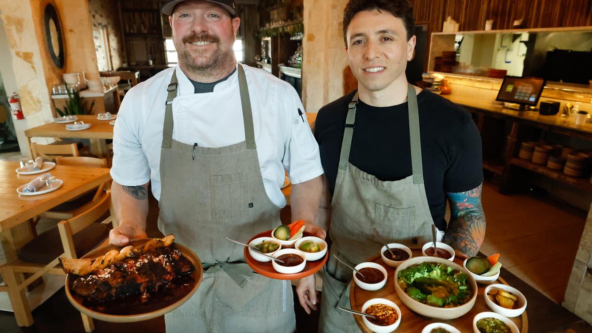 June executive chef Jason Campbell, left, and culinary partner Nick Grecco display a sampling of dishes they created for the Thornton Park restaurant, which was named as part of this year's Florida MICHELIN Guide selection. (Rich Pope/Orlando Sentinel)