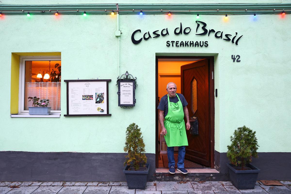 Shoahan Hanan, 63, owner of Casa do Brasil steakhouse stands at the entrance of his restaurant in Schlicht near Vilseck, Germany, May 5, 2026. “A withdraw of 5000 troops in Vilseck, that means a reduction of 50 percent. We will feel the impact.” REUTERS/Lisi Niesner
