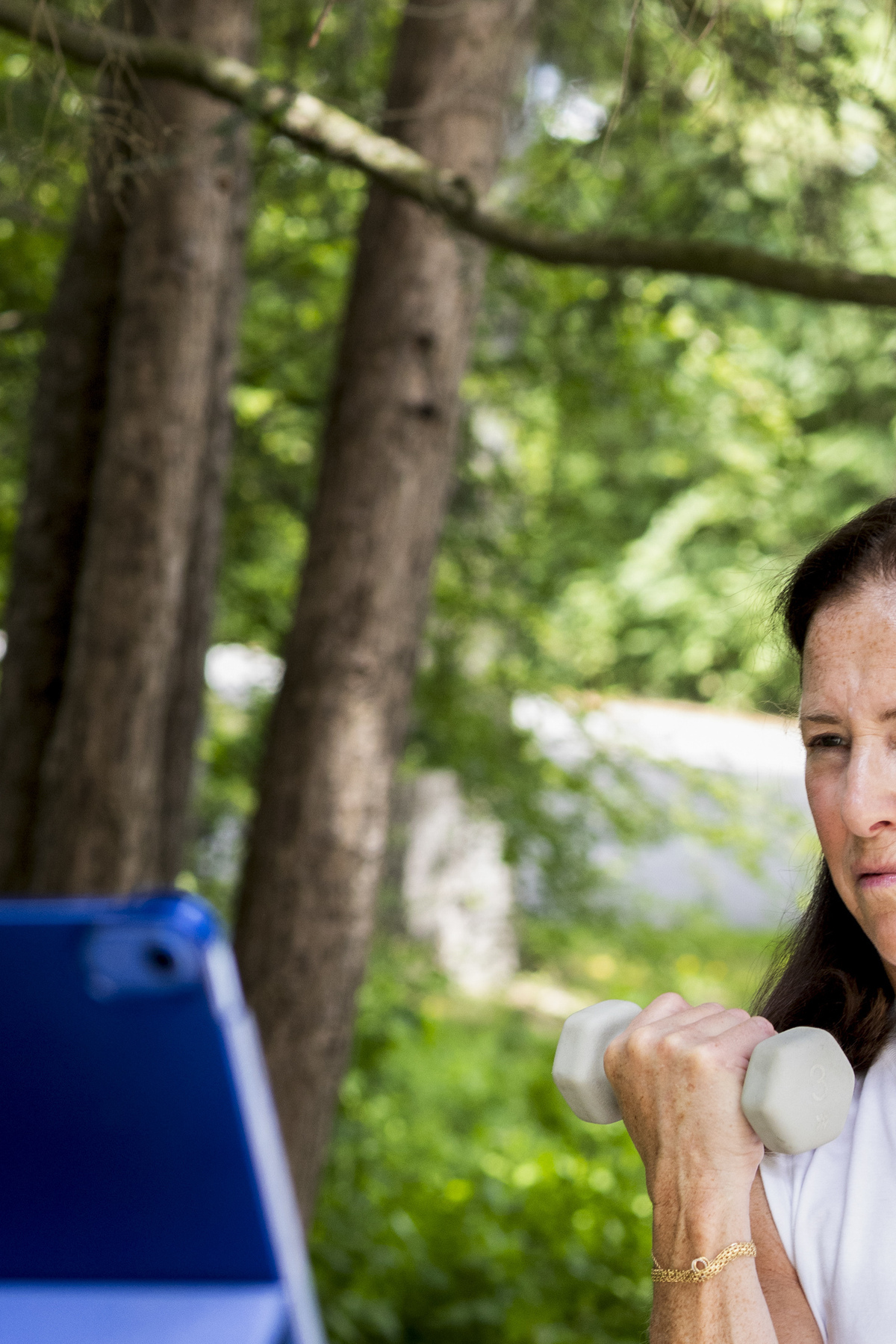 Liz Birenbaum, 60, works out at her home in Chappaqua, N.Y., June 5, 2026. Birenbaum does 30-minute strength sessions twice a week through a midlife workout program. (Frances F. Denny/The New York Times)