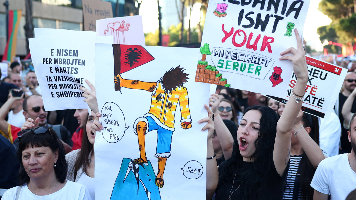 Protesters hold banners during a protest against a luxury resort development planned by a company linked with Donald Trump's son-in-law, Jared Kushner, on an environmentally sensitive part of the Adriatic coast, in Tirana, Albania, June 4, 2026. REUTERS/Florion Goga