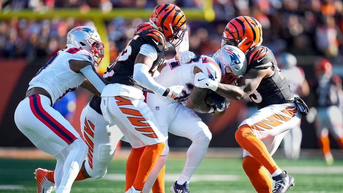  New England Patriots running back TreVeyon Henderson (32) is wrapped up on a carry in the second quarter of the NFL Week 12 game between the Cincinnati Bengals and the New England Patriots at Paycor Stadium in downtown Cincinnati on Sunday, Nov. 23, 2025. | Sam Greene/The Enquirer / USA TODAY NETWORK via Imagn Images 