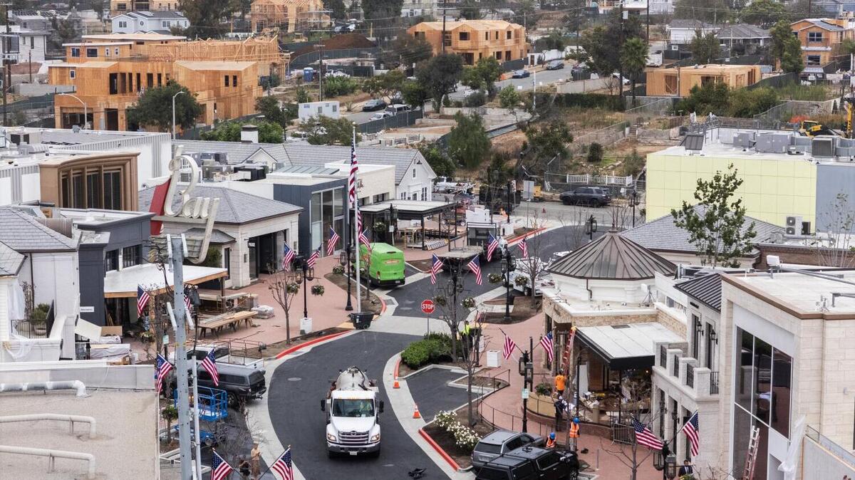 PACIFIC PALISADES, CA - JULY 02, 2026: (THIS IS EMBARGOED UNTIL AFTER JULY 4TH FOR THE OFFICIAL ANNOUNCEMENT) Constuction takes place at Rick Caruso's Palisades Village against a backdrop of home rebuilding in Pacific Palisades, CA on Thursday, July 2, 2026. The shopping center is scheduled to reopen mid-August. (Myung J. Chun / Los Angeles Times)