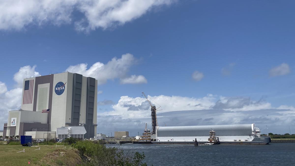 NASA's Pegasus barge arrives to the Kennedy Space Center on Monday, April 27, 2026. Within the barge is the majority of the Space Launch System rocket core stage that will be used on the Artemis III mission slated to fly in mid 2027. NASA will move the core stage into the Vehicle Assembly Building, left, to be stacked on top of the mobile launcher. (Richard Tribou/Orlando Sentinel/TNS)