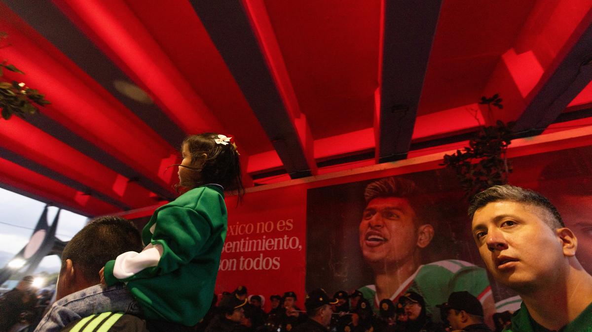 Fans walk near Azteca Stadium, officially renamed Estadio Banorte, on the day of a friendly match between the national teams of Mexico and Portugal held to mark the stadium's inauguration, as Mexico prepares for the 2026 FIFA World Cup co-hosted by the United States, Canada and Mexico, in Mexico City, Mexico, March 28, 2026. REUTERS/Quetzalli Nicte-Ha