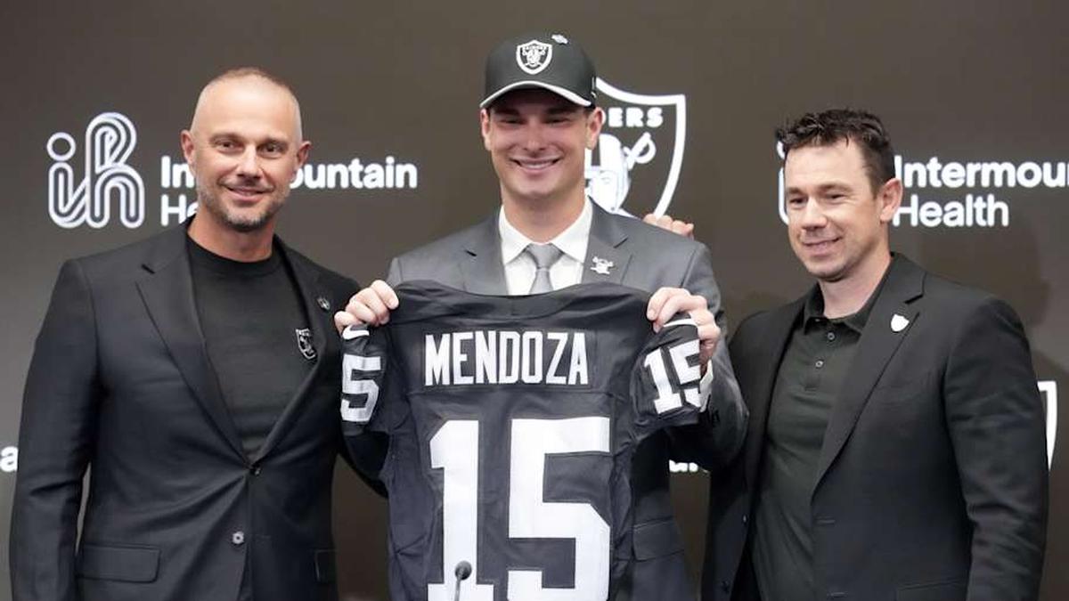  Apr 24, 2026; Henderson, NV, USA; Las Vegas Raiders quarterback Fernando Mendoza (center) poses with jersey with general manager John Spytek (left) and head coach Klint Kubiak at introductory press conference at Intermountain Health Performance Center after being selected as the No. 1 pick in the 2026 NFL Draft. Mandatory Credit: Kirby Lee-Imagn Images | Kirby Lee-Imagn Images 