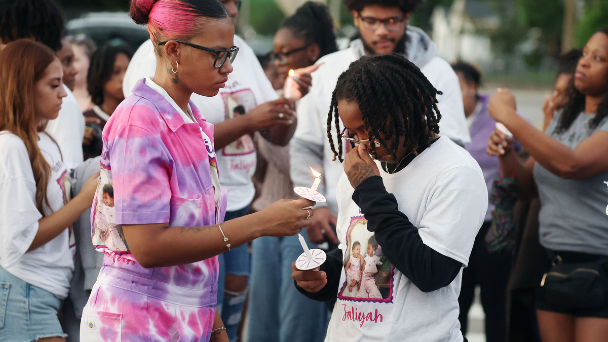 Mourners light candles during a community vigil for 2-year-old Tiana Rae Watts and 1-year-old Jaliyah Katherine Watts outside the Palmetto at Lakeside Apartments in Orlando, Florida, on June 11, 2026. The two children were killed by their father the previous week. (Stephen M. Dowell/Orlando Sentinel/TNS)