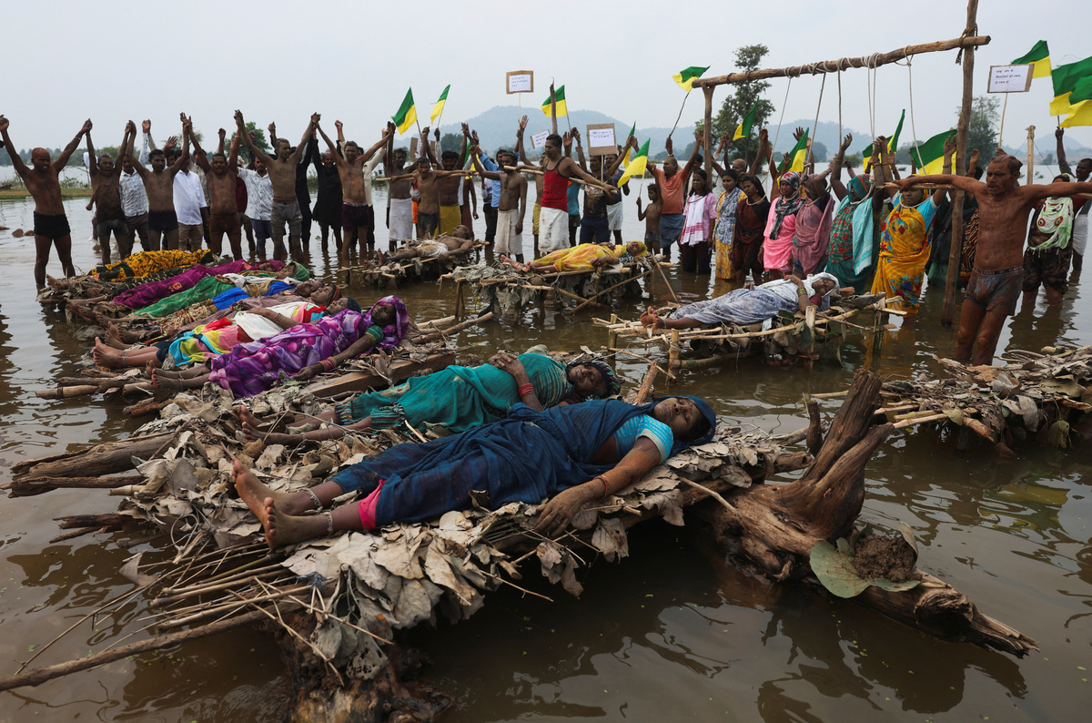 As rising waters flood homes and temples, villagers protest India's $87 ...