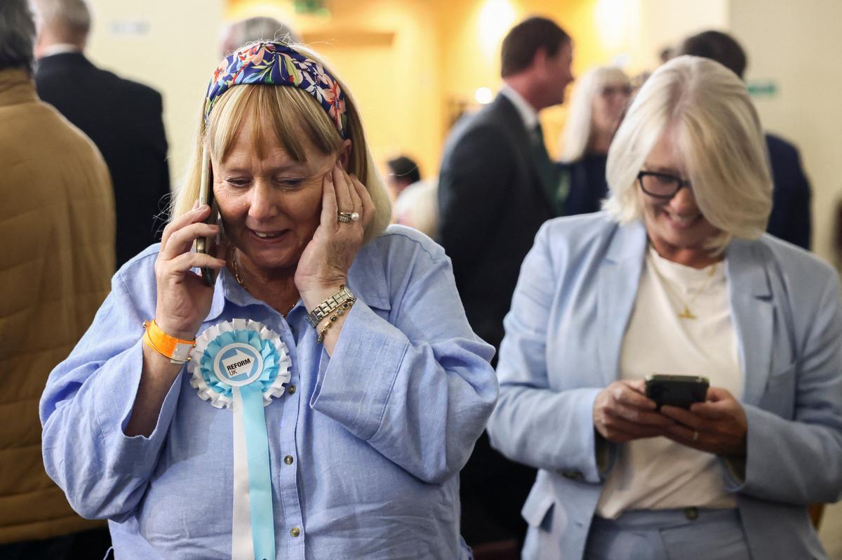 A woman wears a Reform UK party rosette, following the results of the local elections, in the London Borough of Havering, Britain, May 8, 2026. REUTERS/Jack Taylor
