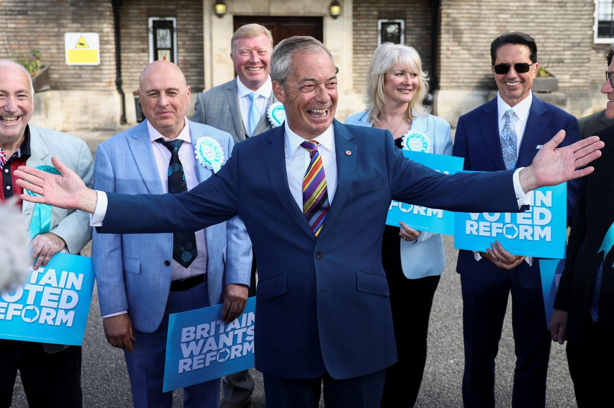 Britain's Reform UK leader Nigel Farage reacts next to newly elected councillors at the Havering Town Hall, following the results of the local elections, in the London Borough of Havering, Britain, May 8, 2026. REUTERS/Jack Taylor