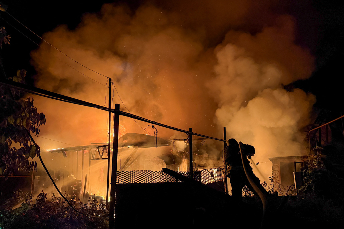 A firefighter works at the site of a private house that burns after an overnight Russian drone strike, amid Russia's attack on Ukraine, in Zaporizhzhia, Ukraine June 22, 2026. Picture taken with a mobile phone. REUTERS/Serhii Chalyi
