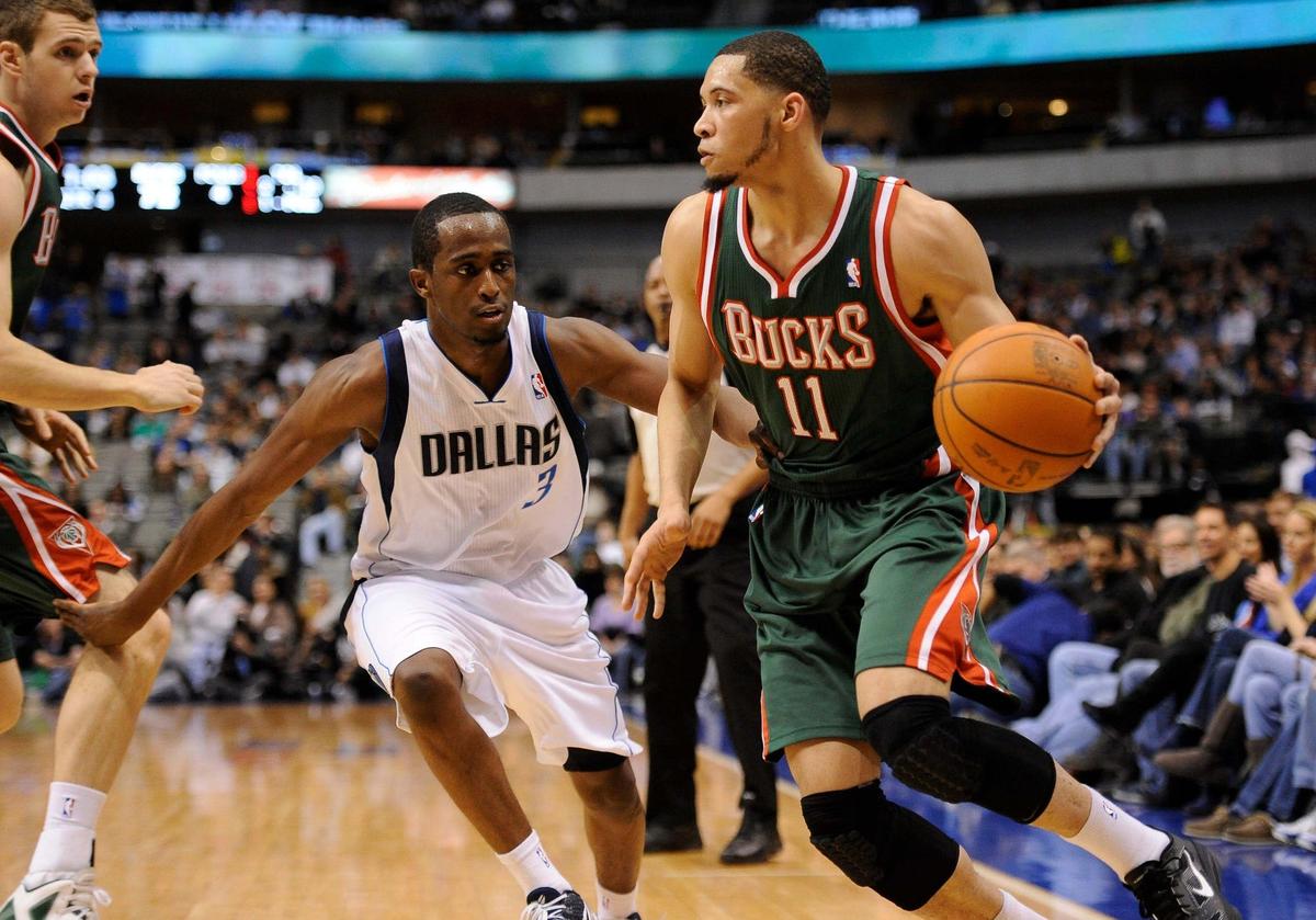 Jan 13, 2012; Dallas, TX, USA; Milwaukee Bucks rookie forward Darington Hobson (11) dribbles the ball past Dallas Mavericks guard Rodrigue Beaubois (3) during the fourth quarter at the American Airlines Center. The Mavericks defeated the Bucks 102-76. Mandatory Credit: Jerome Miron-USA TODAY Sports