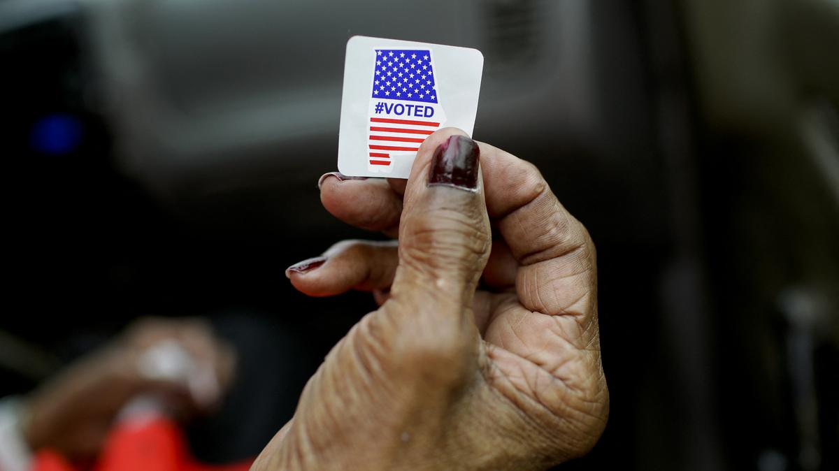 US-POLITICS-VOTE. Sadie Janes shows off her voting sticker after casting her ballot at Floyd Middle Magnet School during the Democratic presidential primary in Montgomery, Alabama on Super Tuesday, March 3, 2020.