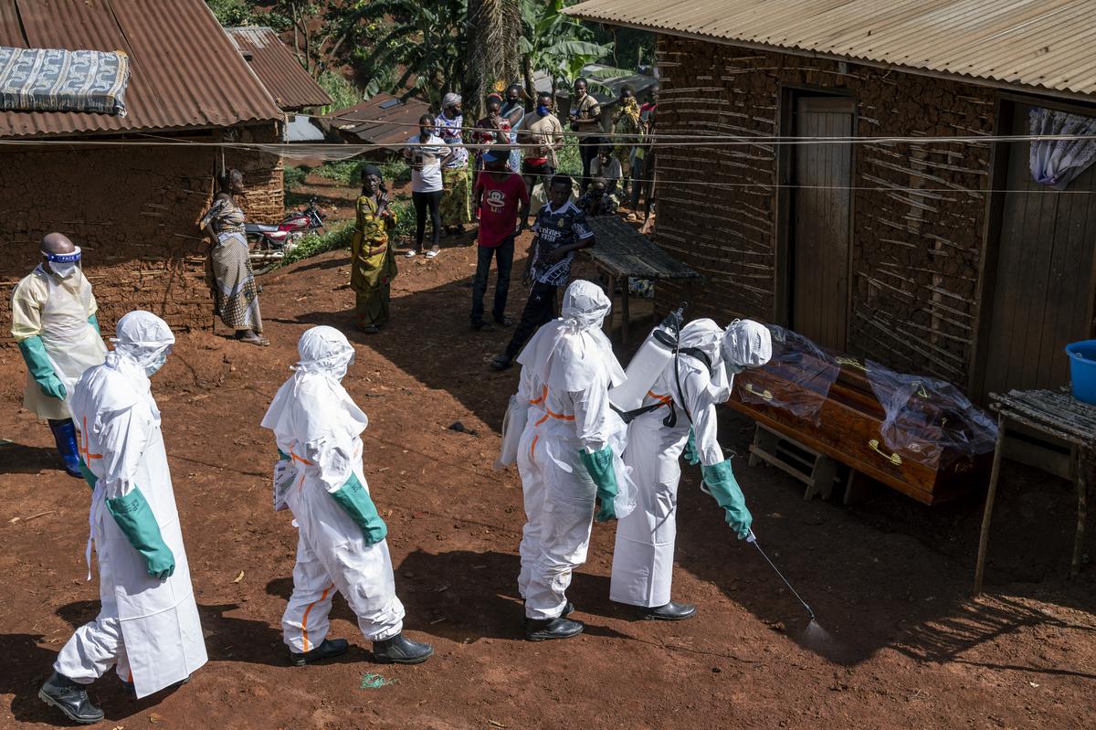 Health workers disinfect the entrance to a house before removing the body of a person whose suspected cause of death was Ebola, in Mongbwalu, Democratic Republic of Congo, May 24, 2026. In a remote gold mining town at the epicenter of the Ebola outbreak, medical workers struggle to beat back a surge of deaths and infections. (Arlette Bashizi/The New York Times)