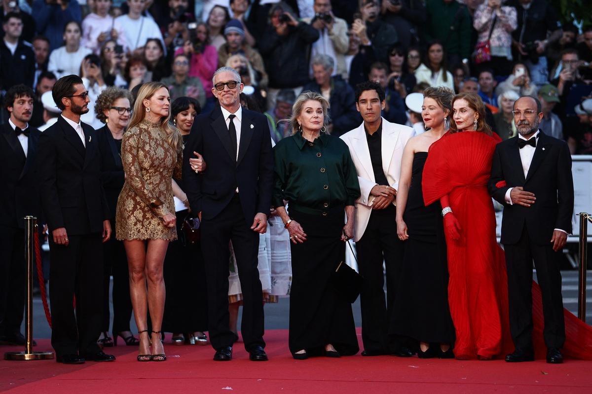 Director Asghar Farhadi and cast members Vincent Cassel, Virginie Efira, Isabelle Huppert, Catherine Deneuve, Pierre Niney, Adam Bessa and India Hair pose on the red carpet during arrivals for the screening of the film "Histoires paralleles" (Parallel Tales) in competition at the 79th Cannes Film Festival in Cannes, France, May 14, 2026. REUTERS/Marko Djurica