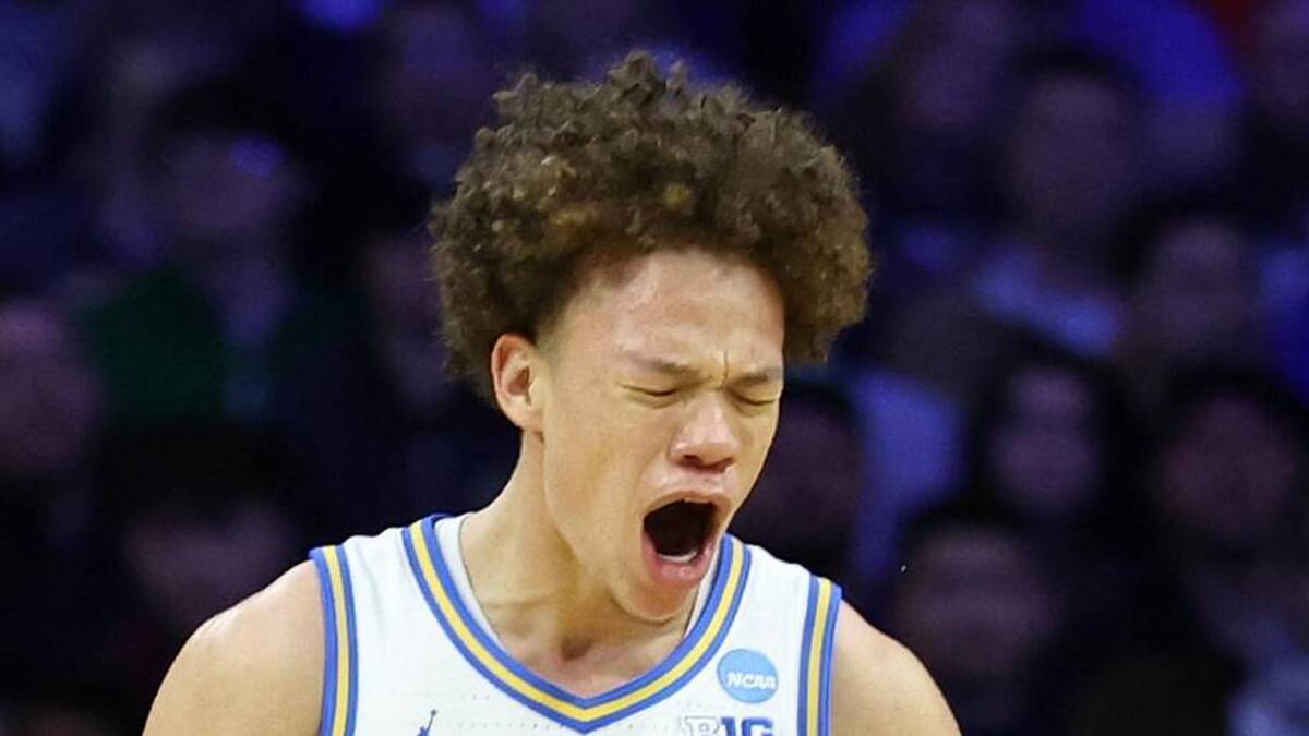  Mar 20, 2026; Philadelphia, PA, USA; UCLA Bruins guard Trent Perry (0) reacts with guard Eric Freeny (8) in the second half during a first round game of the men's 2026 NCAA Tournament at Xfinity Mobile Arena. Mandatory Credit: Bill Streicher-Imagn Images | Bill Streicher-Imagn Images 