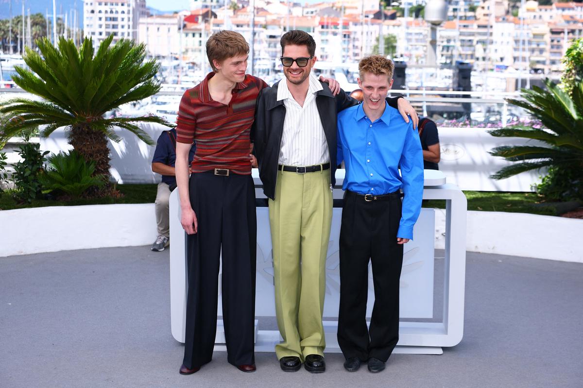 Director Lukas Dhont and cast members Valentin Campagne and Emmanuel Macchia pose during a photocall for the film "Coward" in competition at the 79th Cannes Film Festival in Cannes, France, May 22, 2026. REUTERS/Manon Cruz