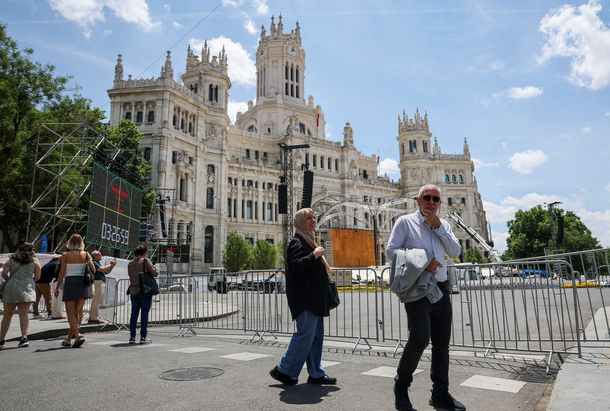 People walk near the altar from which Pope Leo XIV is expected to lead a Mass, during preparations ahead of Pope Leo XIV's upcoming visit, at Cibeles Palace in Madrid, Spain, June 5, 2026. REUTERS/Mohammed Salem