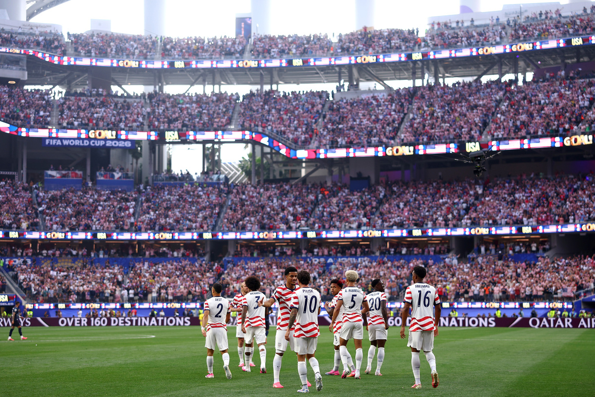  Players of the United States celebrate their side’s first goal, an own goal by Damian Bobadilla #16 of Paraguay (not pictured), during the FIFA World Cup 2026 Group D match between USA and Paraguay at Los Angeles Stadium on June 12, 2026 in Los Angeles, California. 
