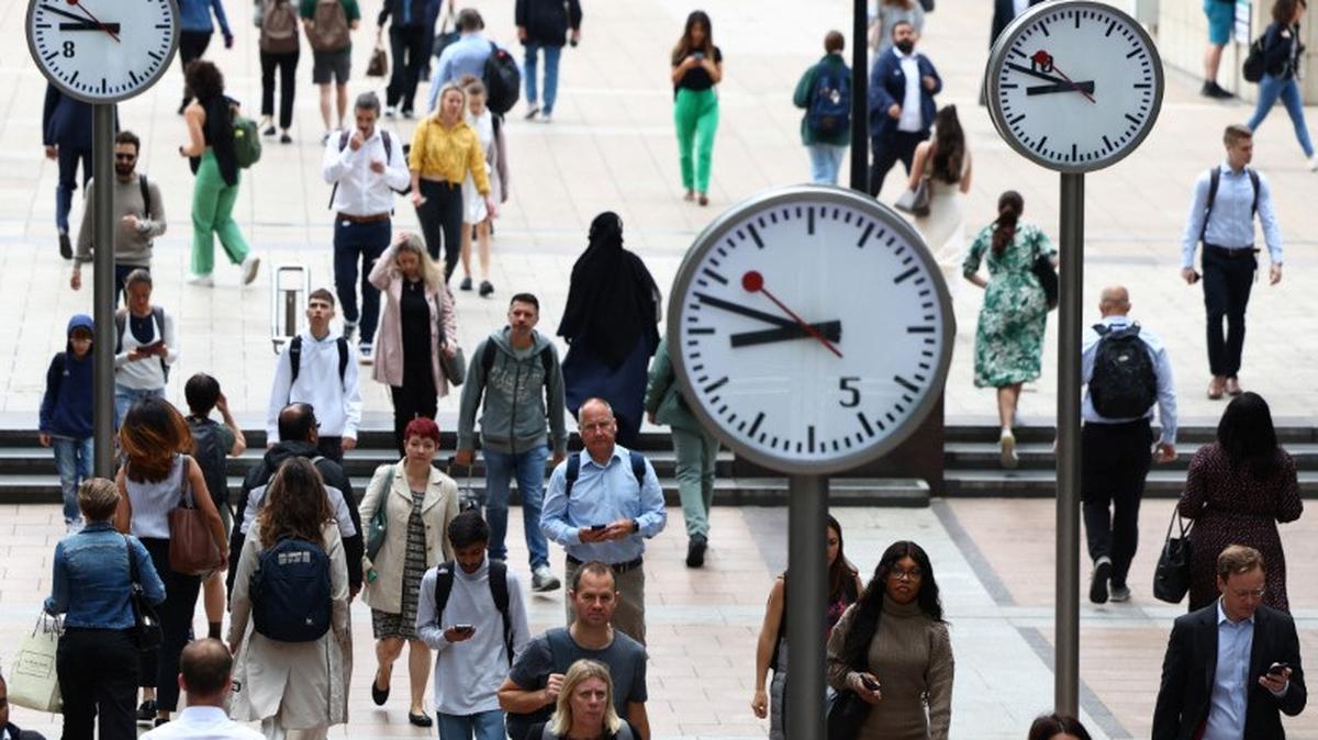 Workers walk through the Canary Wharf financial district, ahead of a Bank of England decision on interest rate changes, in London, Britain, August 3, 2023. REUTERS/Toby Melville