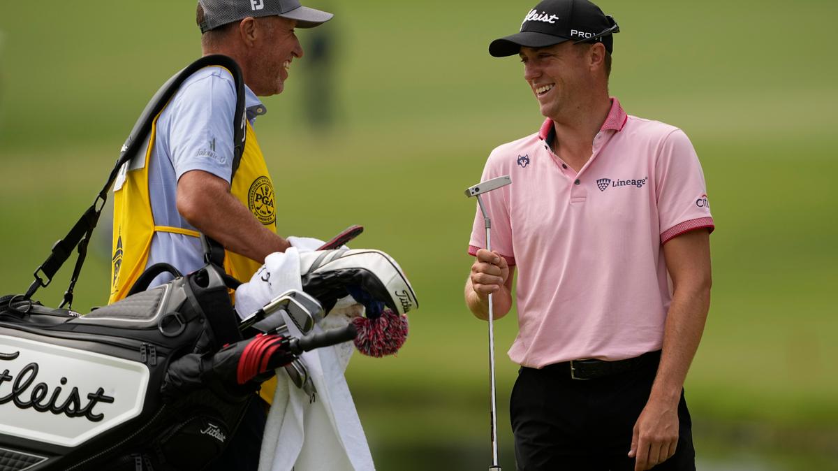 Justin Thomas celebrates after a birdie with his caddie on the 11th hole during the final round of the PGA Championship golf tournament at Southern Hills Country Club, Sunday, May 22, 2022, in Tulsa, Okla. (AP Photo/Matt York)