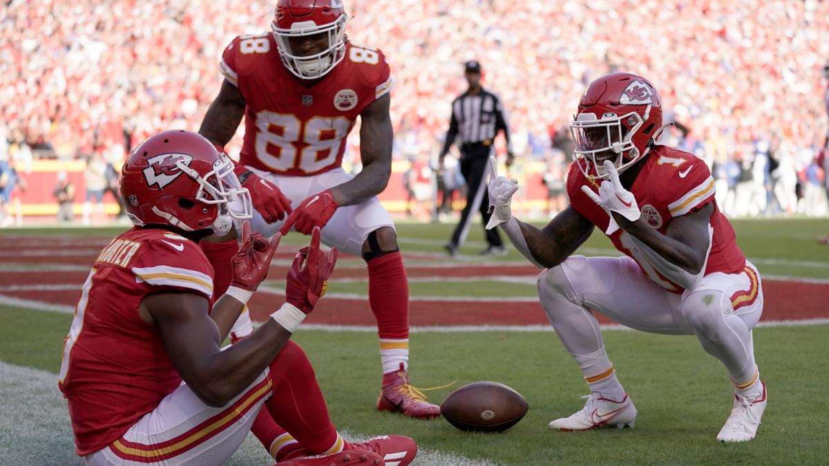 Kansas City Chiefs wide receiver JuJu Smith-Schuster is congratulated by teammates Jody Fortson (88) and Jerick McKinnon (1) after scoring during the first half of an NFL football game against the Buffalo Bills Sunday, Oct. 16, 2022, in Kansas City, Mo. (AP Photo/Ed Zurga)