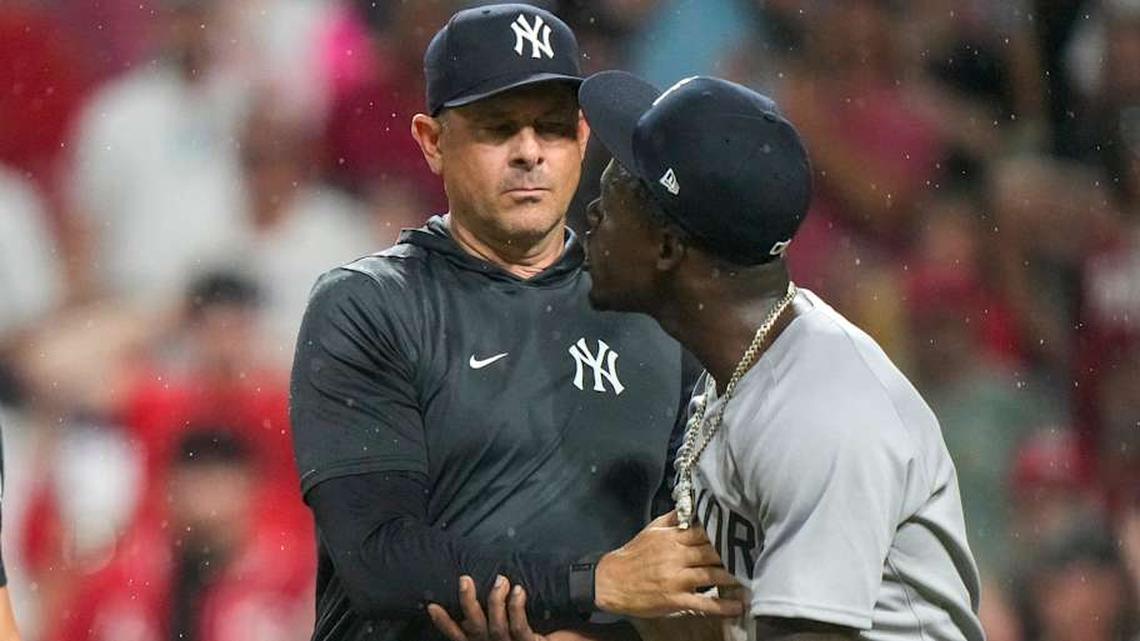  New York Yankees second base Jazz Chisholm Jr. (13) is held back by manager Aaron Boone (17) after being ejected by home plate umpire Mark Wegner (14). | Sam Greene/The Enquirer / USA TODAY NETWORK via Imagn Images 