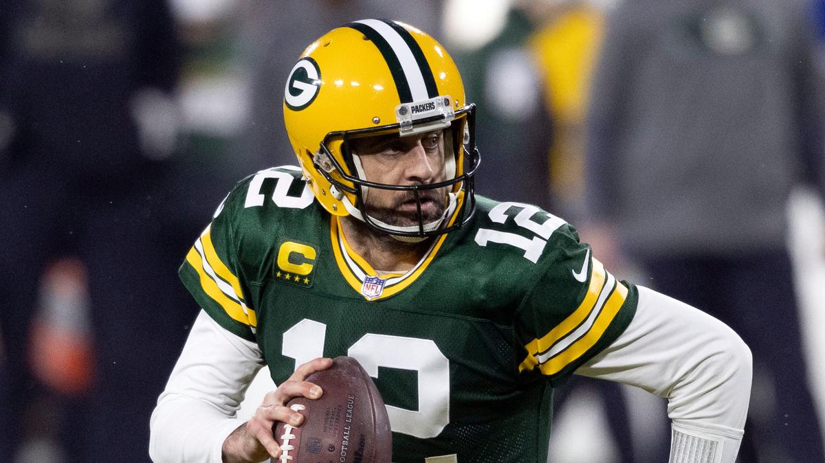 FILE - In this Jan. 16, 2021, file photo, Green Bay Packers quarterback Aaron Rodgers (12) runs during an NFL divisional playoff football game against the Los Angeles Rams in Green Bay, Wis. Packers general manager Brian Gutekunst says the team remains committed to Rodgers “for the foreseeable future” one year after trading up in the first round to draft the three-time MVP’s potential successor. (AP Photo/Jeffrey Phelps, File)