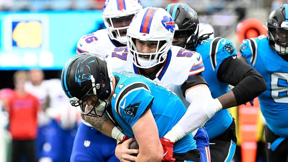 Oct 26, 2025; Charlotte, North Carolina, USA; Carolina Panthers quarterback Andy Dalton (14) is sacked by Buffalo Bills defensive end AJ Epenesa (57) in the fourth quarter at Bank of America Stadium. Mandatory Credit: Bob Donnan-Imagn Images | Bob Donnan-Imagn Images 