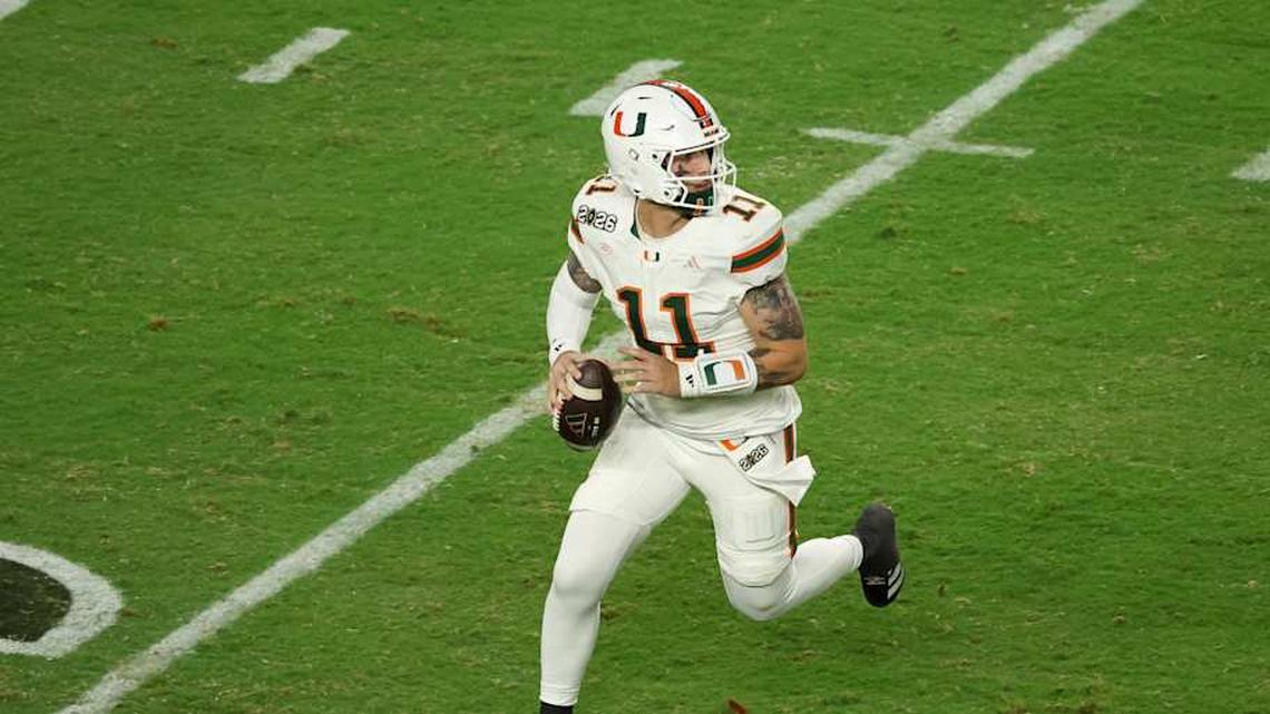  Jan 19, 2026; Miami Gardens, FL, USA; Miami Hurricanes quarterback Carson Beck (11) scrambles with the ball against the Indiana Hoosiers in the third quarter during the College Football Playoff National Championship game at Hard Rock Stadium. Mandatory Credit: Kim Klement Neitzel-Imagn Images | Kim Klement Neitzel-Imagn Images 