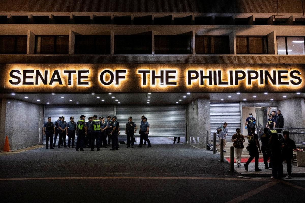 FILE PHOTO: Police officers stand outside the Senate building, after gunshots were heard at the Philippine Senate, as chaos mounted in anticipation of an attempt to arrest a top senator wanted by the International Criminal Court, in Pasay City, Metro Manila, Philippines, May 13, 2026. REUTERS/Eloisa Lopez/File Photo