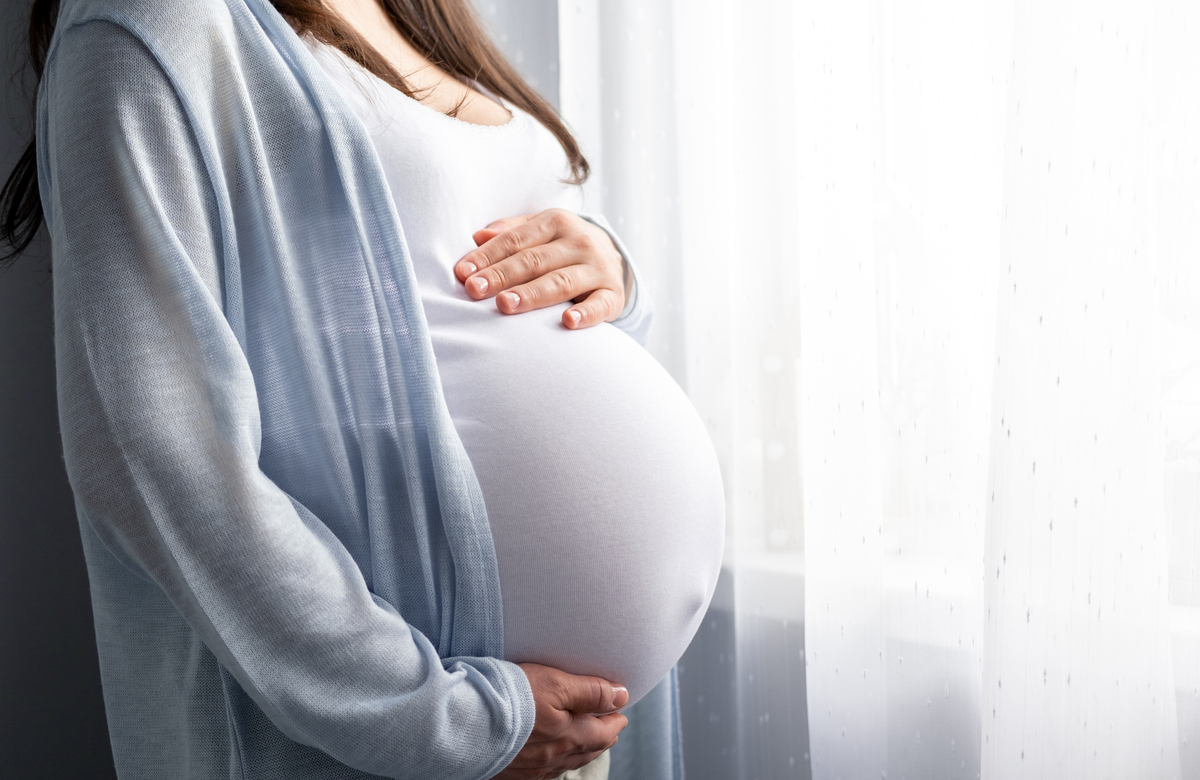  Stock image/file photo: A pregnant woman holding their belly. 