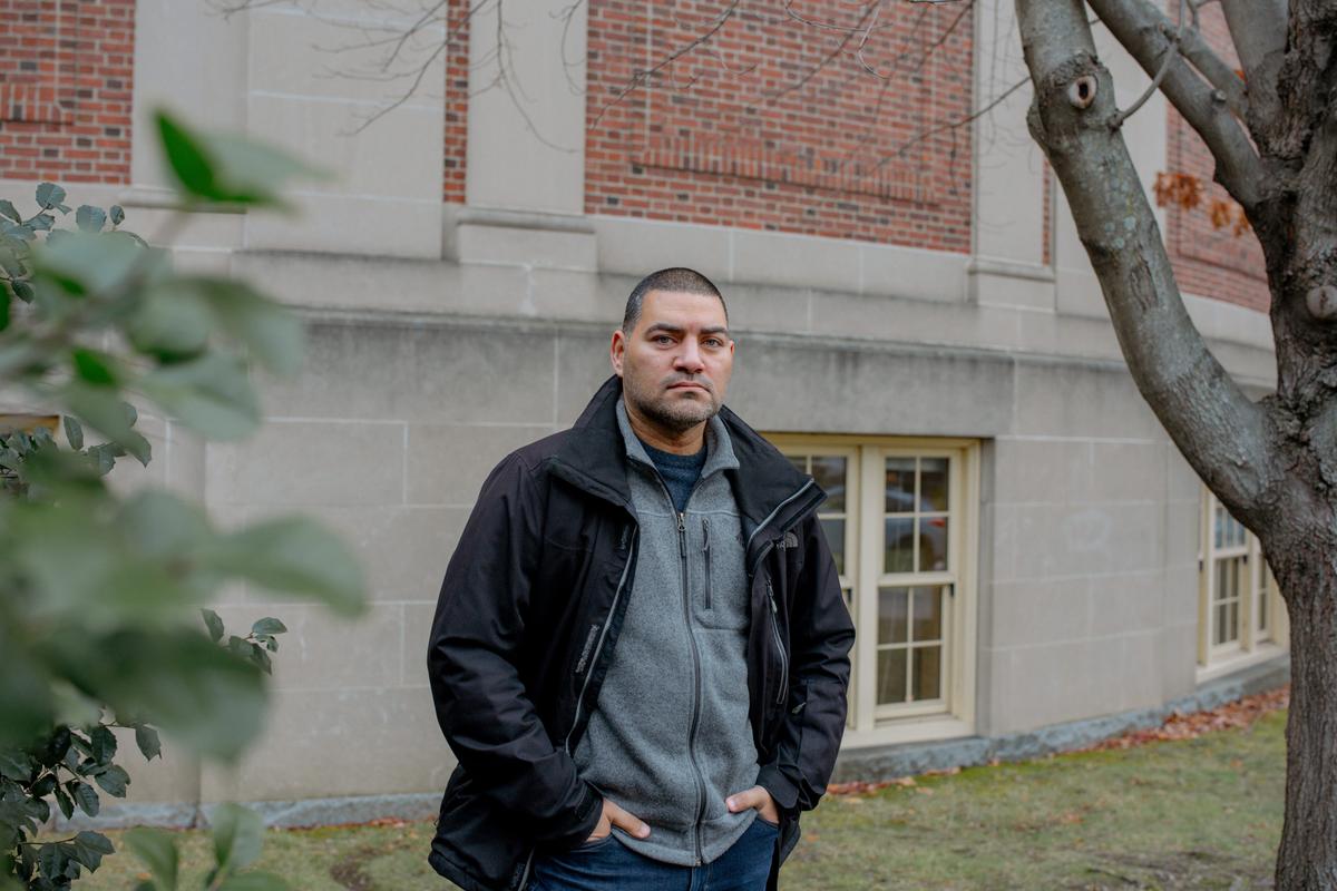  Raul Fernandez, education professor, advocate and founder of Brookline for Racial Justice and Equity, outside of Brookline High School. The district rejected the more than $188,000 his nonprofit raised to save its equity office. Credit: Marianna McMurdock for The Hechinger Report