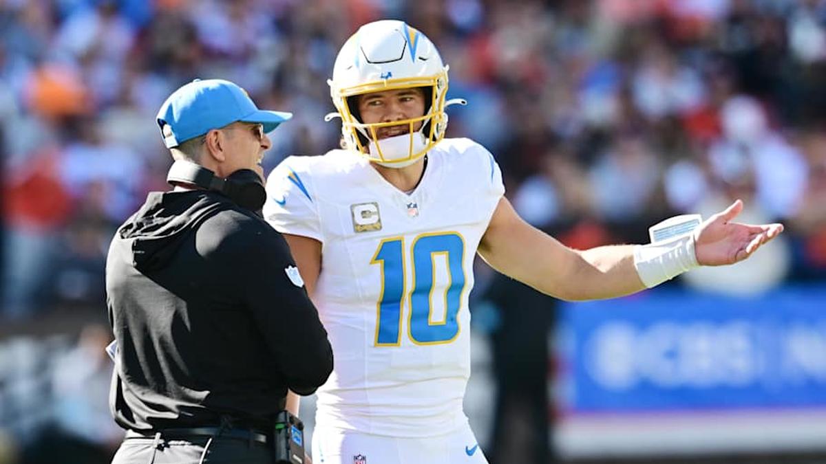 Nov 3, 2024; Cleveland, Ohio, USA; Los Angeles Chargers quarterback Justin Herbert (10) talks to head coach Jim Harbaugh during the first quarter against the Cleveland Browns at Huntington Bank Field. Mandatory Credit: Ken Blaze-Imagn Images | Ken Blaze-Imagn Images 