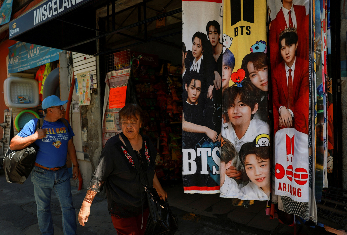 FILE PHOTO: People walk past blankets featuring South Korean Kpop boy band BTS displayed for sale in a shop ahead of concerts on the BTS world tour "Arirang", as the bond between Korea and Mexico, one of the world’s more unusual geo-cultural connections, continues to grow, with Korean influence gaining a foothold despite distance, language barriers and a 15-hour time difference, in Mexico City, Mexico, April 29, 2026. REUTERS/Henry Romero/File Photo
