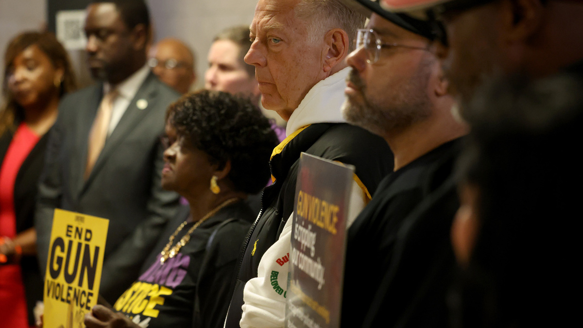 The Rev. Michael Pfleger, center, joins other faith leaders and activists at Chicago City Hall on June 22, 2026, to call for a designated gun violence prevention office. (Antonio Perez/Chicago Tribune/TNS)