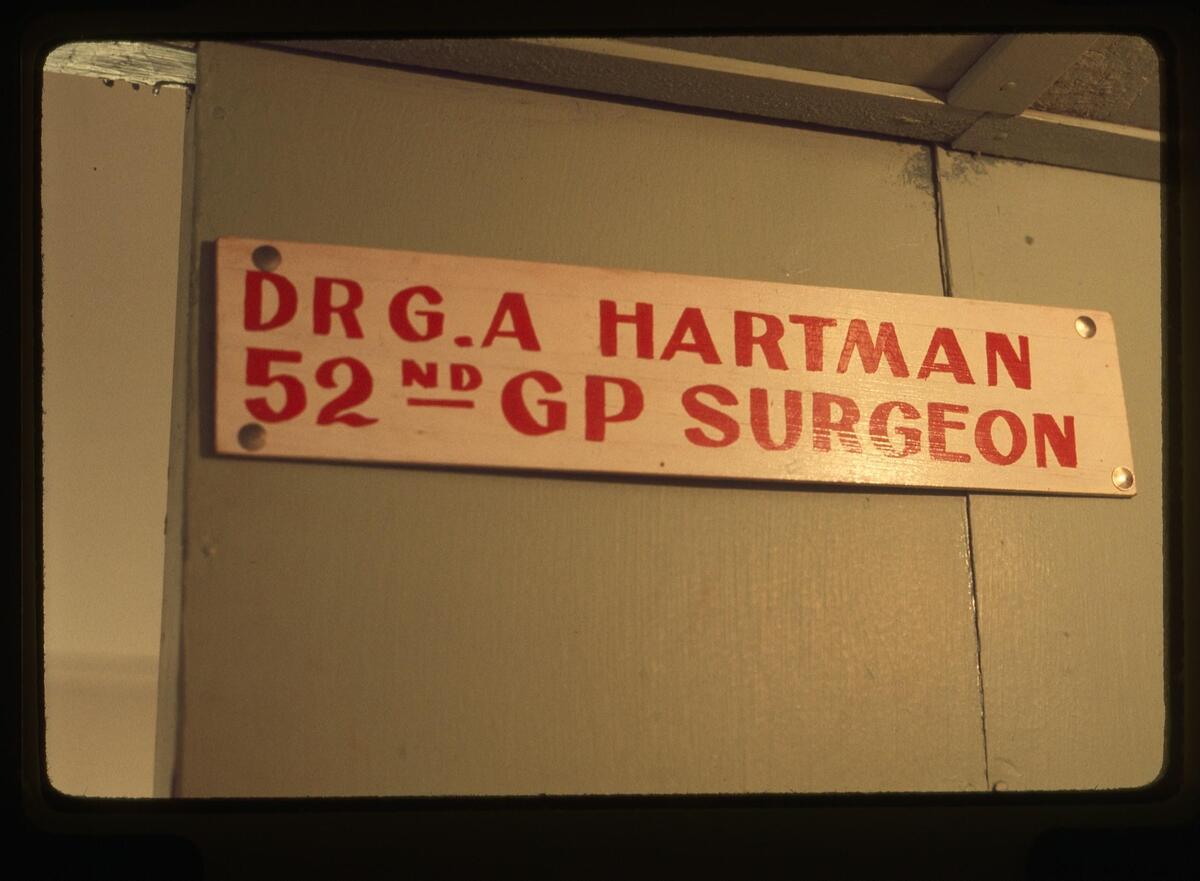  Gary Hartman took numerous slide photos throughout his tour in Vietnam. This sign hung on his office door in Pleiku, Vietnam. (Photo by Gary Hartman) 