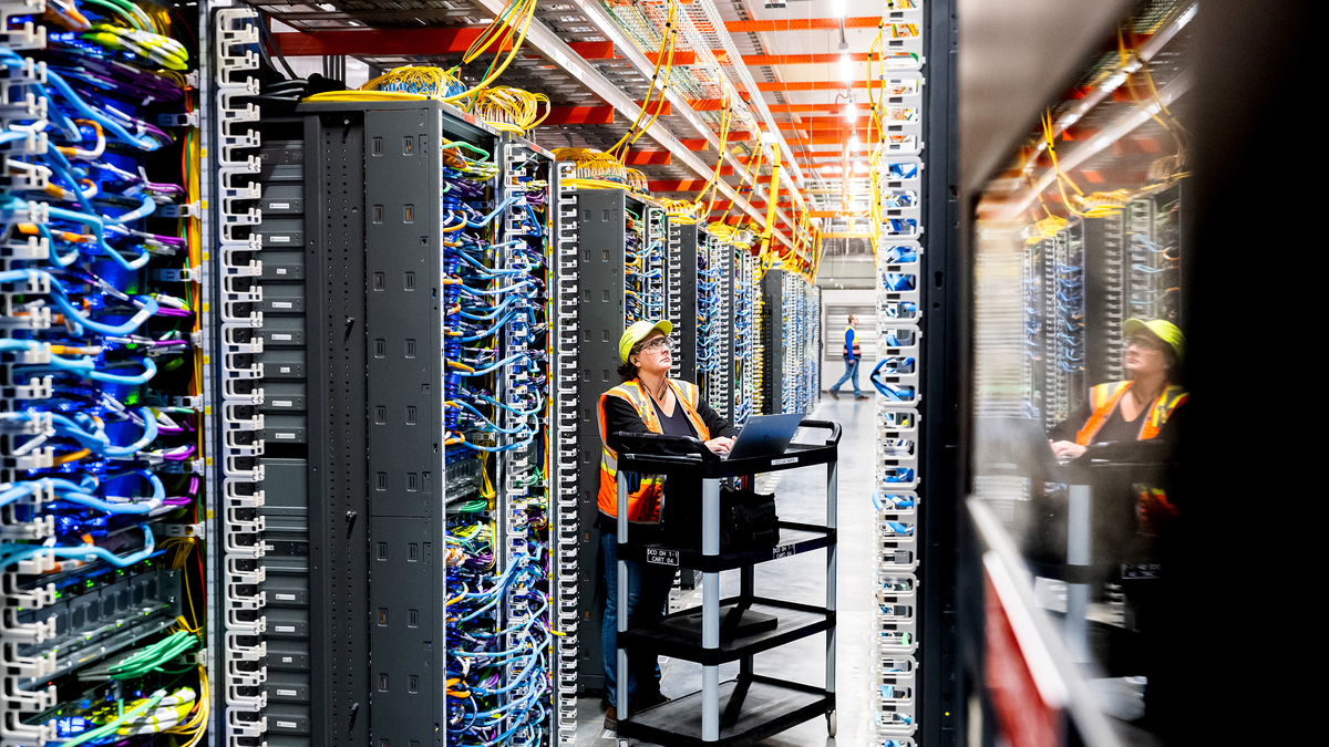 In this handout provided by Amazon, a technician works at an Amazon Web Services AI data center in New Carlisle, Indiana, on Oct. 2, 2025. (Noah Berger/Amazon Web Services/Getty Images/TNS)