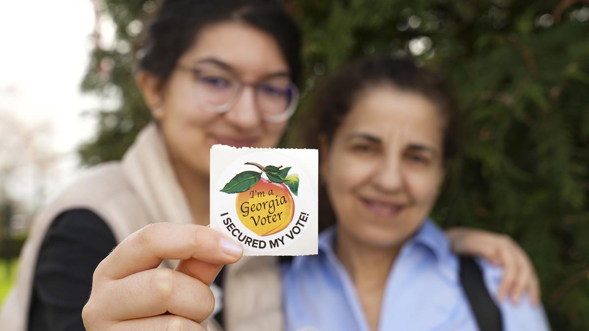 Layla Al-Mondalek and Jeanne Nassif pose for a photo with their voting sticker on Election Day for Congressional District 14, on March 10, 2026, in Dalton, Georgia. (Megan Varner/Getty Images/TNS)